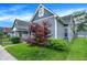 Charming gray two-story home featuring a well-maintained lawn and manicured landscaping at 1531 English Ave, Indianapolis, IN 46201