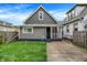 Charming gray two-story home with a well-maintained lawn and a concrete driveway at 1531 English Ave, Indianapolis, IN 46201