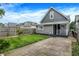 Charming two-story home with a well-maintained lawn, mature tree, and concrete driveway at 1531 English Ave, Indianapolis, IN 46201