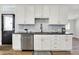 Kitchen features white cabinetry, stainless steel appliances, black countertops, and tiled backsplash at 1531 English Ave, Indianapolis, IN 46201