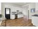 Bright kitchen features white cabinetry, stainless steel appliances, and wood flooring at 1531 English Ave, Indianapolis, IN 46201