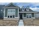Charming single-Gathering home with an inviting craftsman-style front porch and beautiful green siding at 15352 Cardonia Rd, Fishers, IN 46037