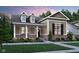 Charming home featuring a brick foundation, neutral siding, dormer windows and a welcoming front porch at 15352 Cardonia Rd, Fishers, IN 46037
