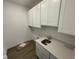 Functional laundry room equipped with cabinetry, sink, and ample counter space at 15352 Cardonia Rd, Fishers, IN 46037