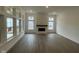 Open living room with a fireplace feature and abundant natural light from the large windows at 15352 Cardonia Rd, Fishers, IN 46037