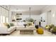 Open concept living area with a kitchen, white sofa, decorative pillows, and a wooden coffee table at 15352 Cardonia Rd, Fishers, IN 46037