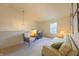 Cozy bedroom featuring neutral walls, comfortable seating, and a sunlit window at 15460 Follow Dr, Noblesville, IN 46060
