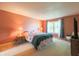 Bright bedroom with a queen bed, two side tables, and a view of the yard at 15460 Follow Dr, Noblesville, IN 46060