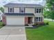 Charming two-story home boasts a two-car garage and well-manicured lawn at 15460 Follow Dr, Noblesville, IN 46060