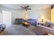 Comfortable living room with ample seating, neutral tones, and a ceiling fan at 15460 Follow Dr, Noblesville, IN 46060
