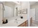 Bright bathroom with a large mirror, white countertops, and wood cabinets providing ample storage space at 15553 Portland Dr, Westfield, IN 46074