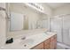 Bright bathroom with a double sink vanity, large mirror, and a glass-enclosed shower at 15553 Portland Dr, Westfield, IN 46074