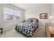 Cozy bedroom featuring a bed with floral bedding, a window, and a dresser at 15553 Portland Dr, Westfield, IN 46074