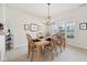 Charming dining room with a wood table, seating for six, and a large window for natural light at 15553 Portland Dr, Westfield, IN 46074