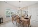 Inviting dining area with a wood table, seating for six, and a large window overlooking the yard at 15553 Portland Dr, Westfield, IN 46074