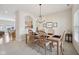 Bright dining room featuring a chandelier, wood table with seating, and pass through to the kitchen at 15553 Portland Dr, Westfield, IN 46074