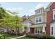 Stylish townhome featuring a brick facade, covered entrance, and landscaped front yard at 15553 Portland Dr, Westfield, IN 46074
