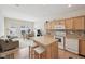 Open-concept kitchen featuring an island, modern appliances, and a view of the dining and living areas at 15553 Portland Dr, Westfield, IN 46074
