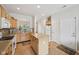 Open kitchen featuring an island, wood cabinets, and modern white appliances at 15553 Portland Dr, Westfield, IN 46074