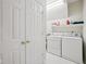 Functional laundry room equipped with a washer, dryer, and storage shelf at 15553 Portland Dr, Westfield, IN 46074