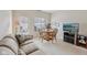 Cozy living room with a round wood dining table, comfortable couch, and natural light from the windows at 15553 Portland Dr, Westfield, IN 46074