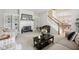 Elegant living room with fireplace, built-in shelves, and staircase at 15553 Portland Dr, Westfield, IN 46074