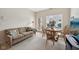 Inviting living space featuring a comfortable couch, round wood dining table, and bright windows at 15553 Portland Dr, Westfield, IN 46074