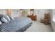 Spacious main bedroom featuring neutral walls, carpeted floors, with a wooden dresser, mirror, and a rocking chair at 15553 Portland Dr, Westfield, IN 46074