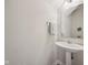 Neat powder room featuring a pedestal sink, mirror, towel rack and neutral paint at 15553 Portland Dr, Westfield, IN 46074