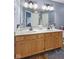 Bright bathroom featuring double sinks with a large mirror, a bathtub, and modern fixtures at 1896 Central Park W Blvd, Greenwood, IN 46143