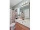 Clean bathroom with a vanity, sink, and a decorative mirror, accented by a patterned shower curtain at 1896 Central Park W Blvd, Greenwood, IN 46143