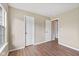 Neutral bedroom featuring wood-look flooring, white doors, and a light, airy ambiance, ready for personalization at 1896 Central Park W Blvd, Greenwood, IN 46143