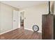 Neutral bedroom with wood-look flooring, a closet, and an open doorway, providing a simple and functional space at 1896 Central Park W Blvd, Greenwood, IN 46143
