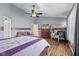 Cozy bedroom with hardwood floors, ceiling fan, comfortable seating area, and a large TV for relaxation at 1896 Central Park W Blvd, Greenwood, IN 46143