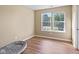 Bright bedroom with wood-look floors, two windows, and ample natural light, creating a cozy and inviting atmosphere at 1896 Central Park W Blvd, Greenwood, IN 46143