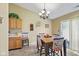 Eat-in kitchen features a dining area with a chandelier and patriotic-themed decor at 1896 Central Park W Blvd, Greenwood, IN 46143