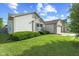 Well-kept home with a tidy front lawn, partial brick facade, and charming shutters on a bright, sunny day at 1896 Central Park W Blvd, Greenwood, IN 46143