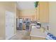 Kitchen with stainless steel appliances, light wood cabinets, and tile flooring at 1896 Central Park W Blvd, Greenwood, IN 46143