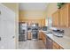 Kitchen with stainless steel appliances, light wood cabinets, and tile flooring at 1896 Central Park W Blvd, Greenwood, IN 46143