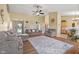 Inviting living room with wood floors, comfortable seating, and a partial view of the kitchen at 1896 Central Park W Blvd, Greenwood, IN 46143