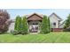 Beautifully landscaped backyard with green grass and patio area at 19281 Scofield Ridge Blvd, Westfield, IN 46074