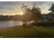 Scenic backyard with a pond and willow tree, providing a peaceful and serene environment at 19281 Scofield Ridge Blvd, Westfield, IN 46074