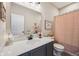 Bright bathroom showcasing a vanity with solid surface countertops, decorative mirror, and shower with stylish patterned curtain at 19281 Scofield Ridge Blvd, Westfield, IN 46074