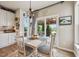 Cozy dining area with modern chandelier, sliding door to the covered patio, and backyard lake views at 19281 Scofield Ridge Blvd, Westfield, IN 46074