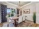 Bright dining room with wooden table, stylish chairs, and large windows at 19281 Scofield Ridge Blvd, Westfield, IN 46074