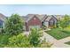 Brick and stone home with a two-car garage, walkway, landscaping, and pristine lawn at 19281 Scofield Ridge Blvd, Westfield, IN 46074