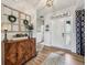 Elegant foyer featuring wood floors, decorative cabinet, and natural light at 19281 Scofield Ridge Blvd, Westfield, IN 46074