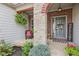 Inviting front porch with stone pillars, gray door, and decorative accents at 19281 Scofield Ridge Blvd, Westfield, IN 46074