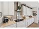 Modern kitchen featuring white cabinetry, stainless steel hood, and decorative accents at 19281 Scofield Ridge Blvd, Westfield, IN 46074