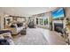 Open-concept living room with fireplace, large windows, and seamless flow to kitchen at 19281 Scofield Ridge Blvd, Westfield, IN 46074